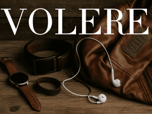 A smart leather wearable collection displayed on a wooden surface, including a brown leather smartwatch, a dark leather smart belt, a leather wristband, and a brown smart leather jacket with integrated tech panel, alongside white earphones.