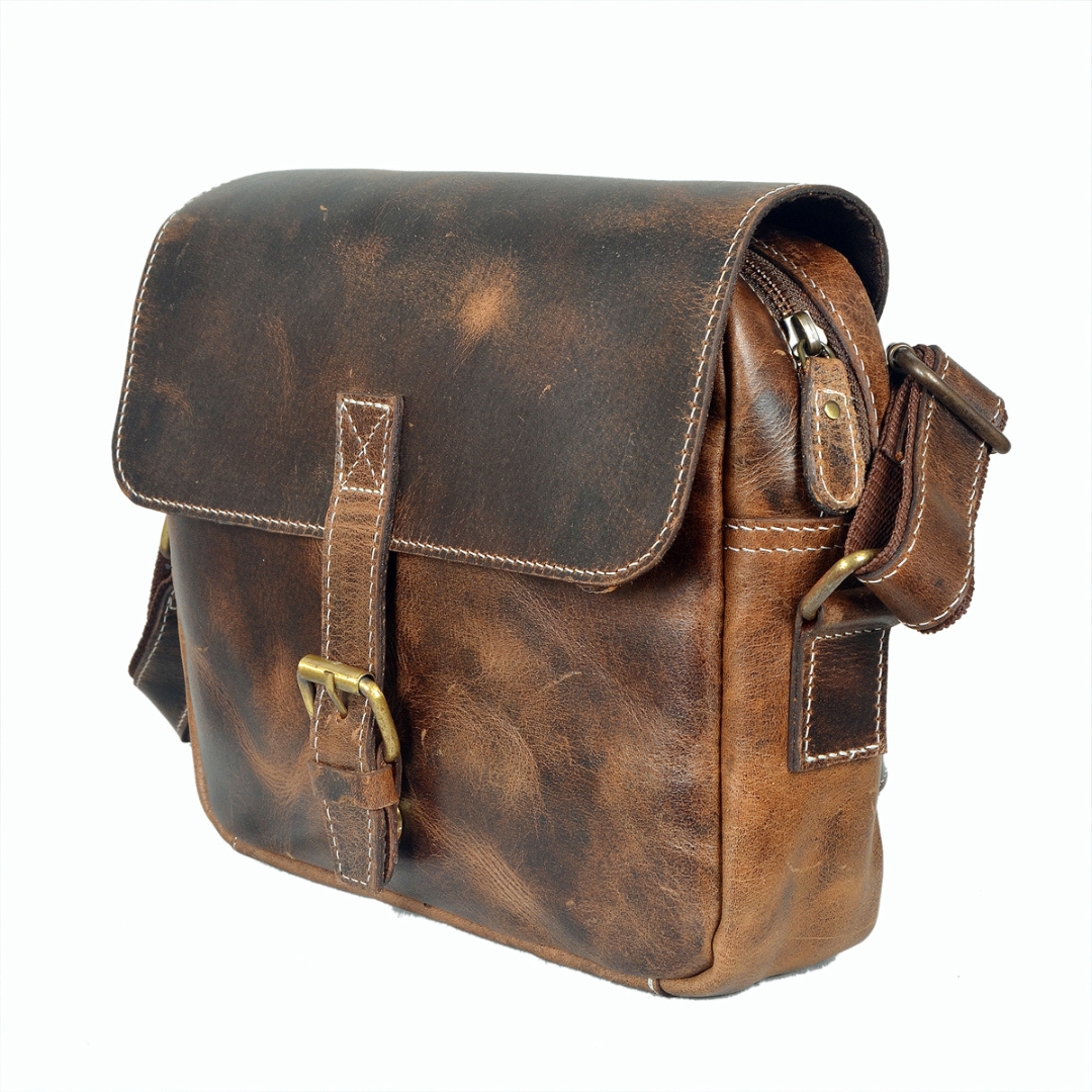 Handcrafted vintage brown leather sling bag with brass buckle and adjustable strap